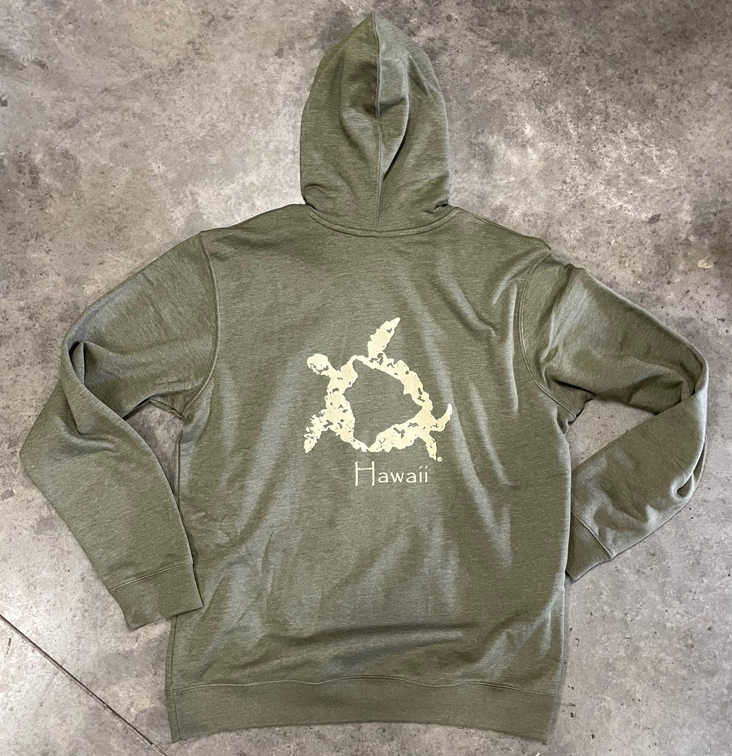 A heather gray hoodie with an olive green hood, featuring a Hawaiian sea turtle petroglyph and the text 'HAWAII' on the back.