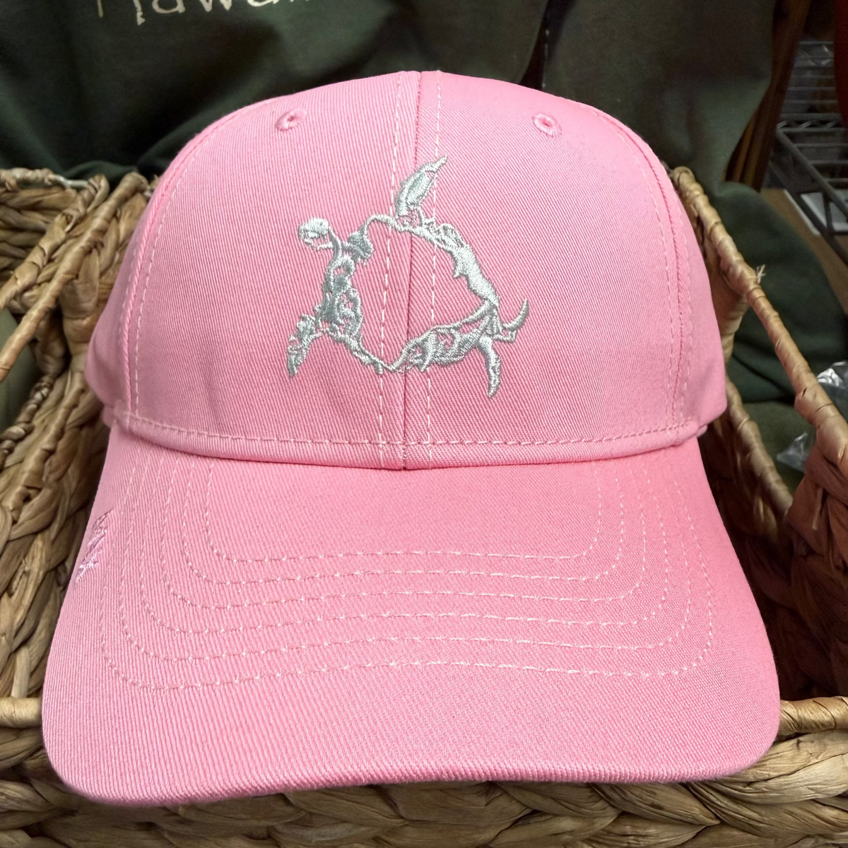 Pink cap with a logo on a woven surface