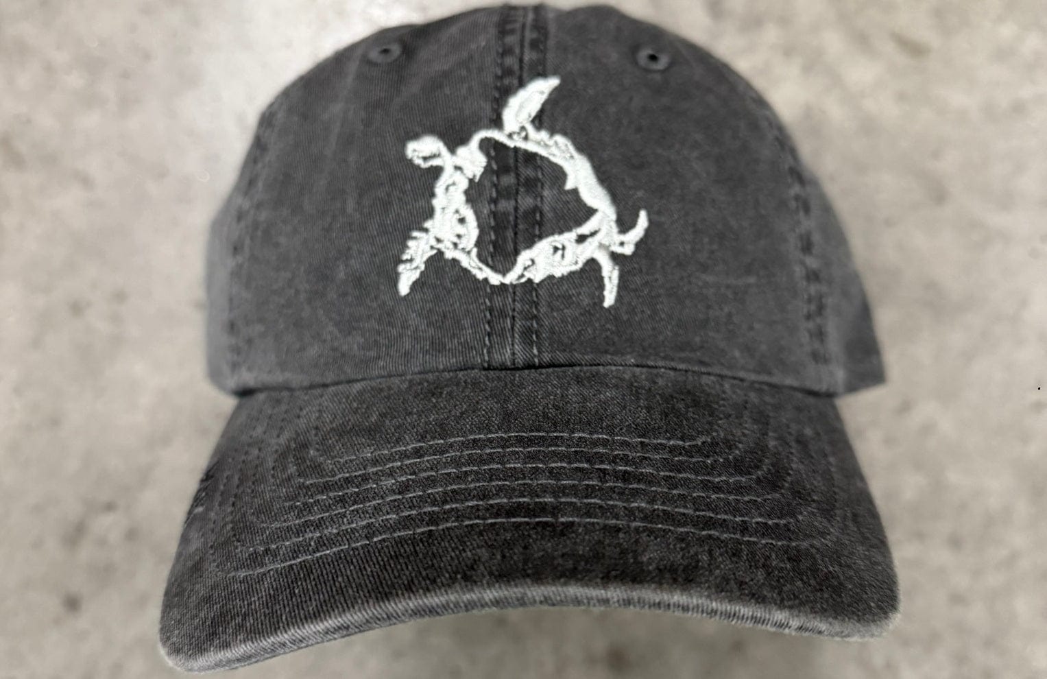 Black cap with a white turtlle petroglyph design