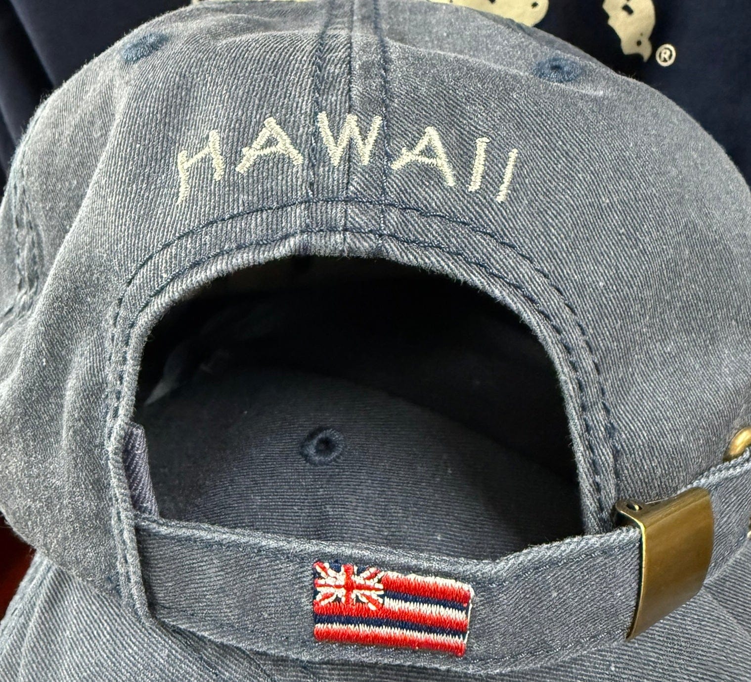 Gray cap with 'HAWAII' embroidery and a flag patch on the back.