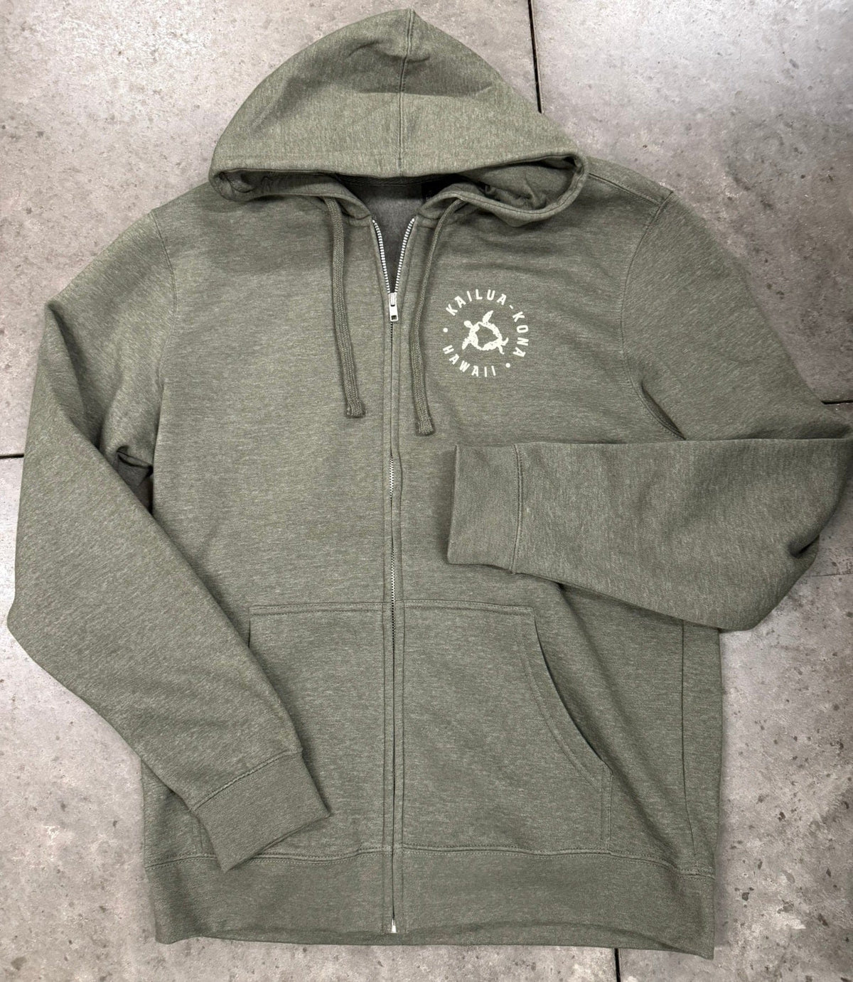 Green hoodie with a logo on a concrete surface